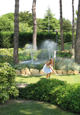 Girl on fairway in front of a fountain
